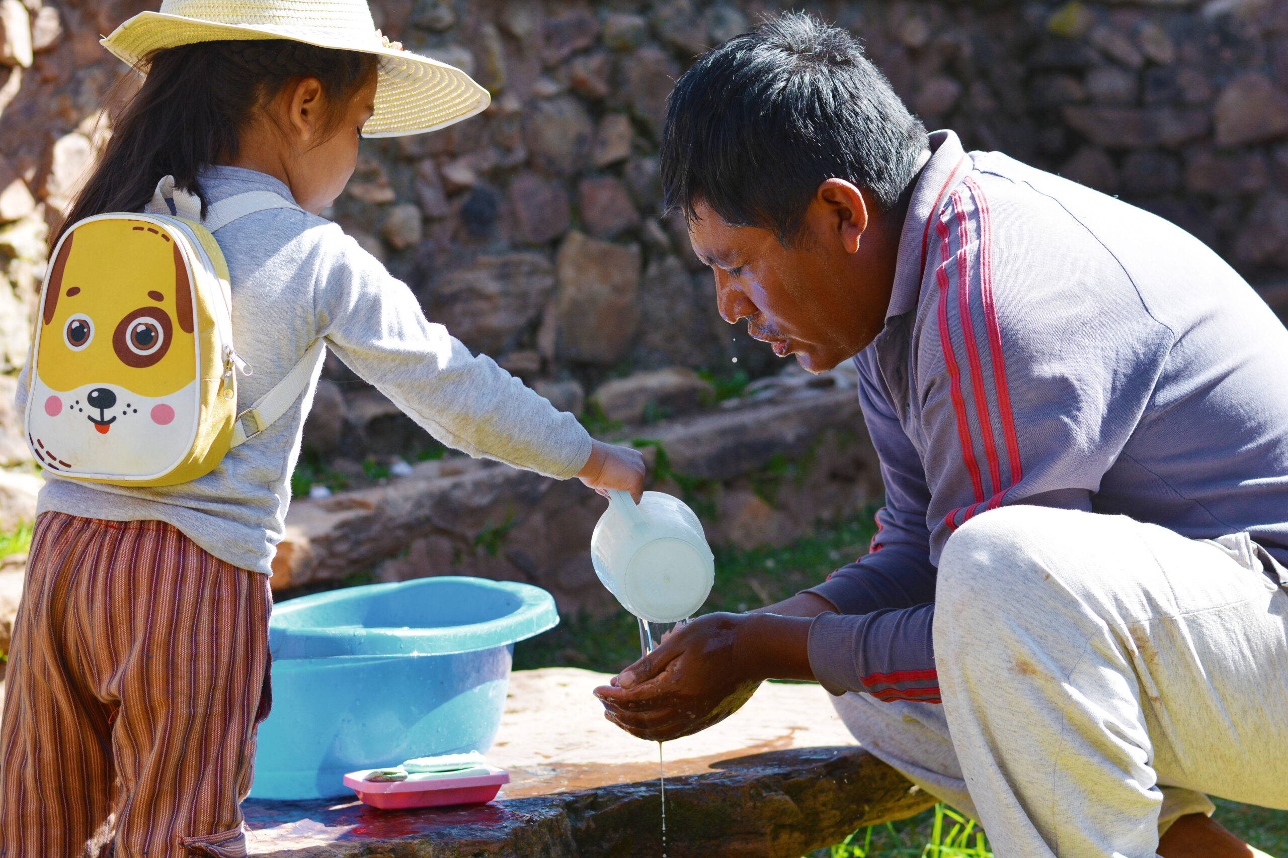 Little girl helping her father to wash the face.